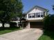 Charming two-story home features a well-manicured lawn, brick accents, and a welcoming entrance at 2628 Newaygo Dr, Indianapolis, IN 46217