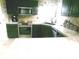 A close-up view of a kitchen with dark cabinets and tile countertops at 2628 Newaygo Dr, Indianapolis, IN 46217