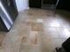 Close up on the floor tiles, fridge, and kitchen appliances at 2628 Newaygo Dr, Indianapolis, IN 46217
