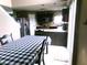 View of an eat-in kitchen with black cabinetry, stainless refrigerator, and black and white checked tablecloth at 2628 Newaygo Dr, Indianapolis, IN 46217