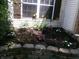 Beautifully landscaped garden bed featuring a variety of colorful flowers and lush greenery adding curb appeal at 2628 Newaygo Dr, Indianapolis, IN 46217