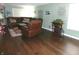 Inviting living room featuring dark wood floors, a green painted walls, and a comfortable leather sectional sofa at 2628 Newaygo Dr, Indianapolis, IN 46217