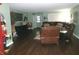 Inviting living room featuring dark wood floors, a green painted walls, and a comfortable leather sectional sofa at 2628 Newaygo Dr, Indianapolis, IN 46217