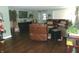 Inviting living room featuring dark wood floors, a green painted walls, and a comfortable leather sectional sofa at 2628 Newaygo Dr, Indianapolis, IN 46217