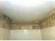 Shower head with white interior walls and decorative accent tile at 2628 Newaygo Dr, Indianapolis, IN 46217
