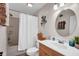 Well-appointed bathroom with a shower-tub combo, decorative mirror and wooden vanity at 2898 Violet W Ct, Columbus, IN 47201