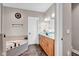 Elegant bathroom featuring double sinks, stylish fixtures, and a luxurious soaking tub at 2898 Violet W Ct, Columbus, IN 47201