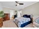 Relaxing bedroom featuring a ceiling fan, dresser, and neutral decor for a serene atmosphere at 2898 Violet W Ct, Columbus, IN 47201