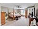 Spacious bedroom with ample natural light, featuring a four-poster bed and stylish furniture at 2898 Violet W Ct, Columbus, IN 47201