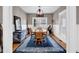 Bright dining room featuring a wooden table, chairs, and a large window at 2898 Violet W Ct, Columbus, IN 47201