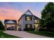 Charming two-story home with stone accents, a covered porch, and a well-manicured lawn at sunset at 2898 Violet W Ct, Columbus, IN 47201