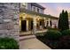 Inviting front porch with brick pillars, rocking chairs, and landscaped garden beds at 2898 Violet W Ct, Columbus, IN 47201