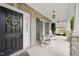 Cozy front porch with rocking chairs and swing offering a relaxing outdoor space with a decorated front door at 2898 Violet W Ct, Columbus, IN 47201
