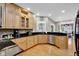 Well-lit kitchen with light wood cabinetry, granite countertops, and stainless steel appliances at 2898 Violet W Ct, Columbus, IN 47201