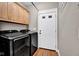 Functional laundry room with modern washer and dryer units, plus cabinet storage at 2898 Violet W Ct, Columbus, IN 47201