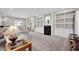 Spacious living room with built-in bookshelves, fireplace, and plush carpeting at 2898 Violet W Ct, Columbus, IN 47201