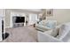 Cozy living room with plush carpet, white sofa, and a staircase to the second floor at 2898 Violet W Ct, Columbus, IN 47201