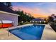 Backyard pool at dusk with privacy fence and nearby trees at 2898 Violet W Ct, Columbus, IN 47201