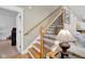 Beautiful staircase featuring wooden steps and wrought iron railings, blending classic design with modern elegance at 2898 Violet W Ct, Columbus, IN 47201