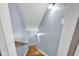 Basement stairwell featuring hardwood steps and light blue walls leading to lower level at 2898 Violet W Ct, Columbus, IN 47201