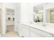Bright bathroom with double vanity, white cabinets, and a large mirror, plus walk-in closet at 3152 Glasgow Pl, Danville, IN 46122