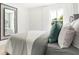 Well-lit bedroom with a modern mirror and a large window overlooking a tree-filled yard at 3152 Glasgow Pl, Danville, IN 46122