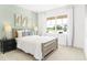 Bright bedroom features a large window, soft carpet, and elegant furnishings for a relaxing retreat at 3152 Glasgow Pl, Danville, IN 46122