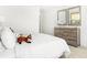 Relaxing bedroom featuring a cozy stuffed fox on a bed, wood dresser, soft lighting, and neutral palette at 3152 Glasgow Pl, Danville, IN 46122