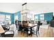 Bright dining area featuring a wooden table with seating for eight and an elegant rectangular chandelier at 3152 Glasgow Pl, Danville, IN 46122