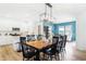 An open concept with modern dining featuring seating for eight, a wooden table, and views of the kitchen at 3152 Glasgow Pl, Danville, IN 46122