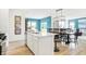 Bright open-concept kitchen featuring a central island, dining area, modern lighting, and views into the living room at 3152 Glasgow Pl, Danville, IN 46122