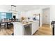 Modern kitchen with stainless appliances, white cabinets, a central island, and open dining and living spaces at 3152 Glasgow Pl, Danville, IN 46122
