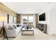 Bright living room featuring a large white sofa, modern decor, and wood-look accent wall at 3152 Glasgow Pl, Danville, IN 46122
