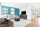 Spacious living room with a blue accent wall, modern furnishings, a neutral sofa and wood floors at 3152 Glasgow Pl, Danville, IN 46122