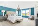 Beautiful bedroom with blue accent wall, large bed, pendant lighting and bright windows at 3152 Glasgow Pl, Danville, IN 46122