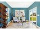 Bright sitting room with views of the yard, modern shelving, and warm interior accents and furnishings at 3152 Glasgow Pl, Danville, IN 46122