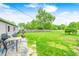 A well-maintained backyard with patio seating, green lawn, and mature trees provides outdoor space at 318 S Routiers Ave, Indianapolis, IN 46219