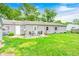 The backyard includes a patio area with outdoor seating and a well-maintained lawn at 318 S Routiers Ave, Indianapolis, IN 46219
