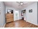 Bedroom featuring wood-look floors, a ceiling fan, a closet, and a dresser topped with a television at 318 S Routiers Ave, Indianapolis, IN 46219