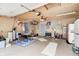 Spacious garage features a table with folding chairs, peg board, and finished ceiling at 318 S Routiers Ave, Indianapolis, IN 46219