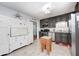 Spacious kitchen featuring dark cabinets, stainless steel appliances, and a butcher block island at 318 S Routiers Ave, Indianapolis, IN 46219