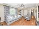 Inviting living room features wood floors, a comfortable gray sofa, recliner and plenty of natural light at 318 S Routiers Ave, Indianapolis, IN 46219