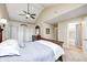 Spacious main bedroom boasts vaulted ceilings, a ceiling fan, a large closet, and access to an ensuite bathroom at 318 S Routiers Ave, Indianapolis, IN 46219
