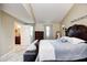 Spacious main bedroom featuring carpeted floors, a ceiling fan, and an ensuite bathroom at 318 S Routiers Ave, Indianapolis, IN 46219