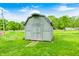 Exterior view of a quaint shed in a grassy backyard, providing additional storage at 318 S Routiers Ave, Indianapolis, IN 46219