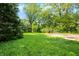 Lush green backyard with trees and a concrete area, perfect for outdoor activities and enjoying nature's tranquility at 3215 E Edgewood Ave, Indianapolis, IN 46227