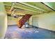 Spacious basement with stairs to main floor and visible ductwork, offering potential for customization and extra storage at 3215 E Edgewood Ave, Indianapolis, IN 46227