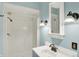 Bathroom featuring a stand-up shower, decorative wall lighting, and a mirror above the sink at 3215 E Edgewood Ave, Indianapolis, IN 46227