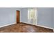 Bedroom featuring blue walls, hardwood floors, and a window at 3215 E Edgewood Ave, Indianapolis, IN 46227