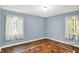 This bedroom offers natural light from two windows and a charming hardwood floor at 3215 E Edgewood Ave, Indianapolis, IN 46227
